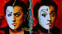 Director Federico Fellini putting on clown makeup